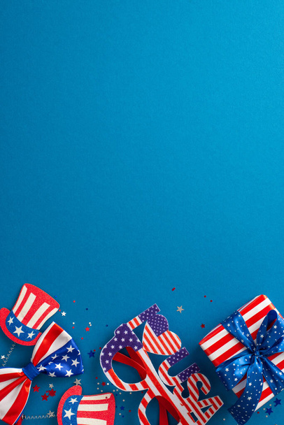 Theme evoking spirit of USA's Independence Day. Vertical top view of party paraphernalia, glitzy confetti, festive headband, party glasses, bow-tie, present, blue background with empty space for text - Foto, Bild