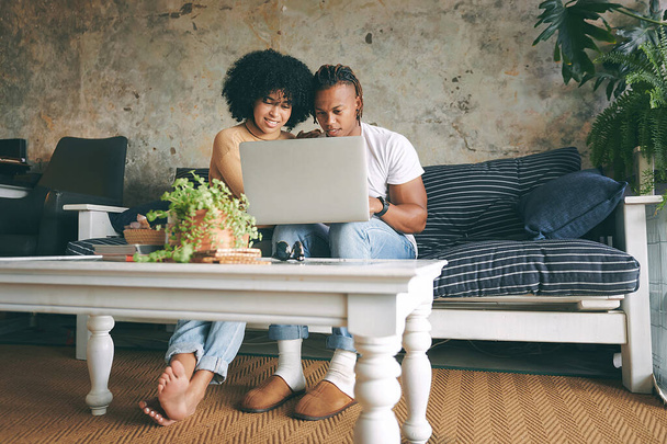 Lets grab a few things online. a young couple using a laptop together at home - Photo, Image