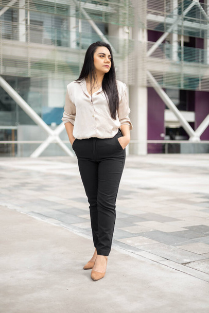 glamorous outfit for office work in blouse and pants, beautiful young woman with black straight hair, entrepreneur posing outside in the city, modern lifestyle - Фото, зображення