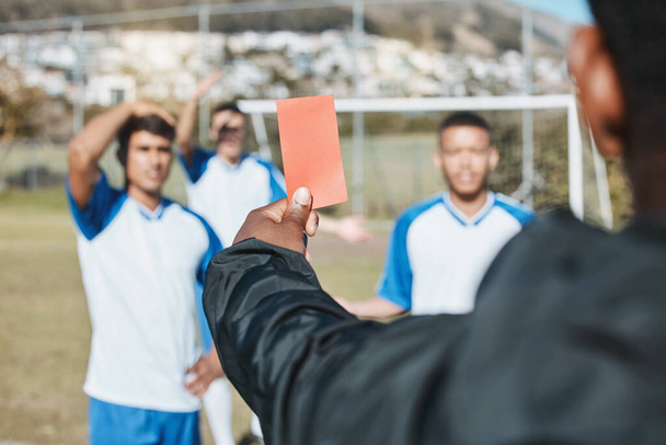 Sports team, red card and soccer referee outdoor on field for game foul, mistake or compliance. Football player, athlete club and paper in person hand for sport warning, penalty rules or dismissal. - Photo, Image