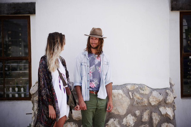Hipster love. a trendy young couple standing together against the wall of a building outside - Foto, Imagem