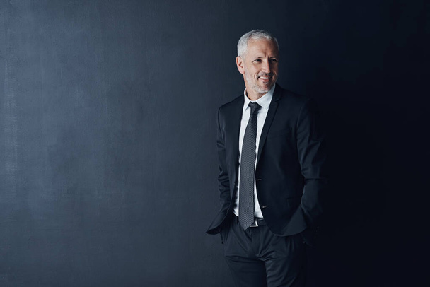 Style that supports his business image. Studio shot of a mature businessman against a dark background - Fotoğraf, Görsel