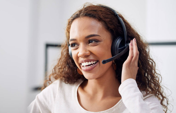 Call center, working and face of woman in customer service office, crm or telemarketing support, help or consulting worker. Contact us, helping consultant and advice in communication or conversation. - 写真・画像