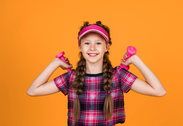 lets train for good health. active lifestyle. sport and fitness activity. cheerful teen girl in sportswear. child hold barbells. kid with dumbbells. back to school. happy and healthy childhood. - Photo, image