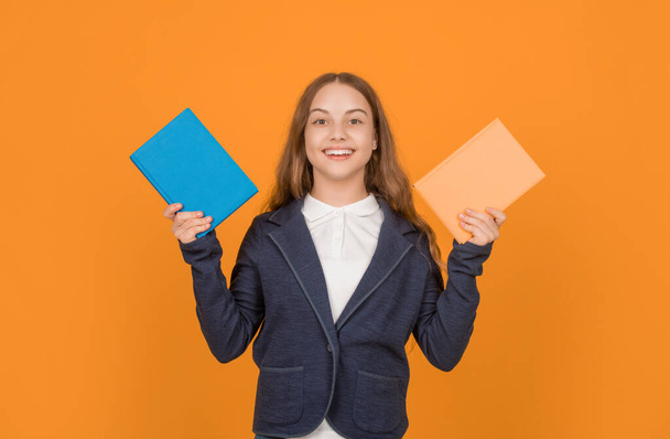 smiling child showing book. back to school. childhood education. knowledge day. kid hold notebook. student in high school. teen girl do homework with copybook. study with workbook. - Φωτογραφία, εικόνα