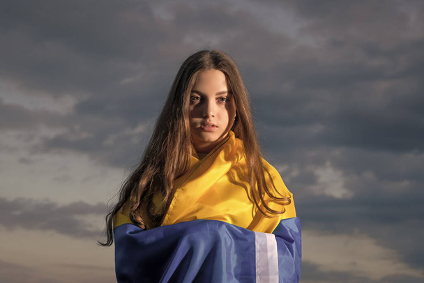 patriotic teen ukrainian girl child with national flag of ukraine. - Foto, afbeelding