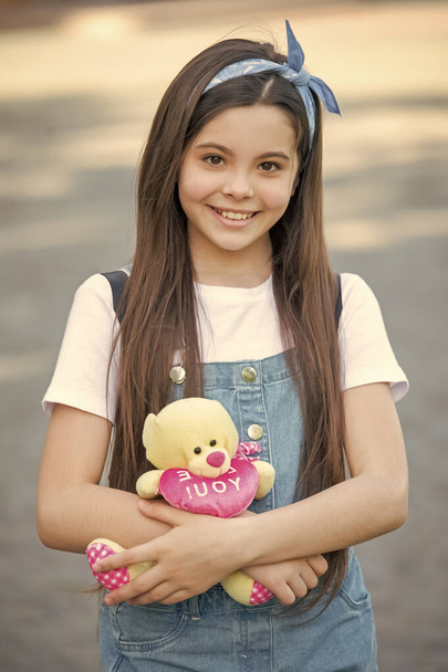 positive cute girl with toy bear outdoor. - Zdjęcie, obraz