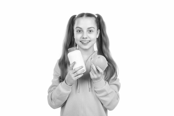 cute girl. effervescent tablet for kids. happy girl hold multivitamin. organic food supplement. choice between natural products and pills. presenting vitamin product. child with orange flavored pill. - Zdjęcie, obraz