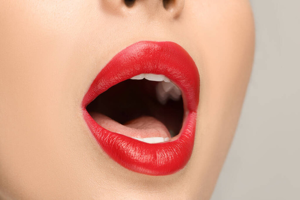 Woman with red lipstick on light background, closeup - Foto, Imagem