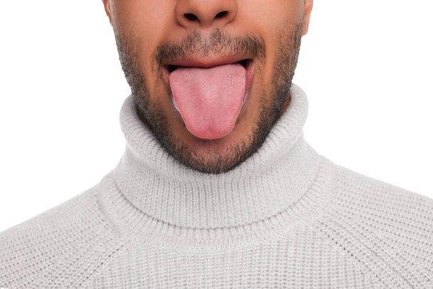 Man showing his tongue on white background, closeup - Fotó, kép