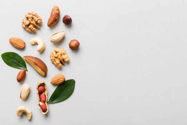 Composition of nuts , flat lay - mix hazelnuts, cashews, almonds on table background. healthy eating concepts and food background. - Valokuva, kuva