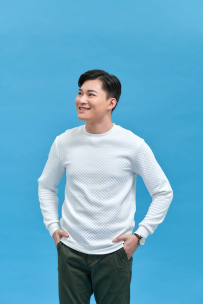 portrait of smiling young handsome Asian man standing  - Foto, afbeelding