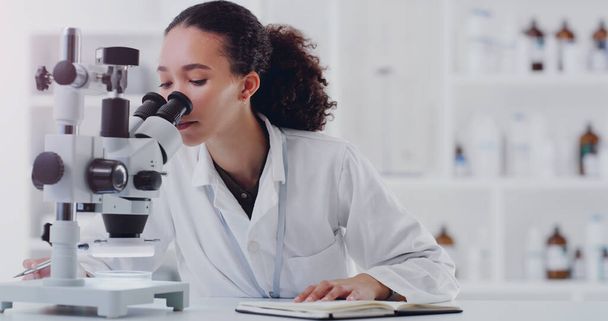 Science, notebook and microscope with woman in laboratory for expert research, medical and planning. Idea, vaccine analysis and medicine with female scientist for chemistry, healthcare and pharma. - Foto, Imagen