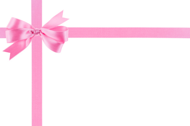 Pink ribbon with a bow on white background - Photo, Image
