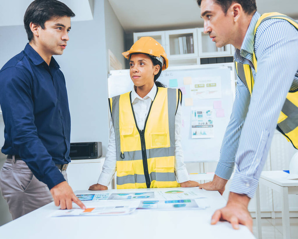 A group of competent engineers and employer discuss plans in the office. Architectural investor, businessman, and engineer discussing blueprints. - Foto, Imagen