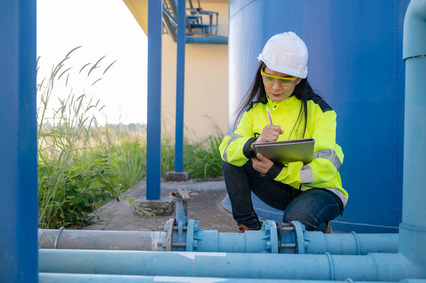 Environmental engineers work at wastewater treatment plants,Female plumber technician working at water supply - Fotó, kép