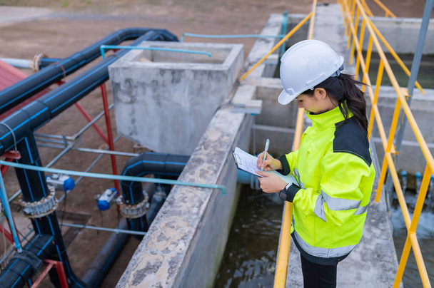 Environmental engineers work at wastewater treatment plants,Water supply engineering working at Water recycling plant for reuse,Check the amount of chlorine in the water to be within the criteria. - Valokuva, kuva