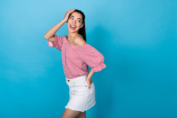 Photo model korean young girl posing preppy look empty space wear trendy outfit shopping offer outfit isolated on blue color background. - Zdjęcie, obraz