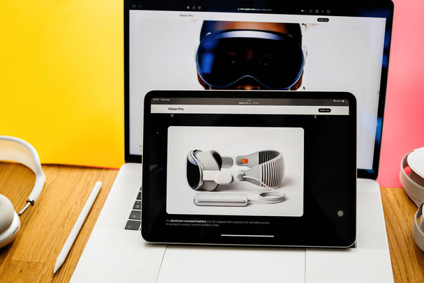 Paris, France - 6 juin 2023 : Table de salon créative avec page web d'Apple sur iPad Pro avec batterie pour casque XR réalité mixte Apple Vision Pro. Prix 3,499 USD - avenir du calcul - Photo, image