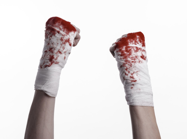 shook his bloody hand in a bandage, bloody bandage, fight club, street fight, violence, bloody theme, black background, isolated, bloody fists, boxer, tied his hands with a bandage, white background - Foto, imagen