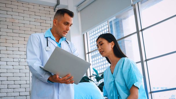 Doctor in professional uniform examining patient at hospital or medical clinic. Health care , medical and doctor staff service concept. Jivy - Photo, image