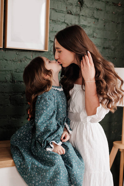 Mother's day. Sensitive young mom embraces her little adorable daughter at home. Trust, support and love between mommy and child. Loving family enjoy tender sweet moments and tight hugs. Children day. - Fotografie, Obrázek