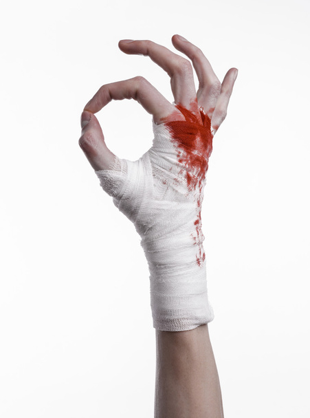 shook his bloody hand in a bandage, bloody bandage, fight club, street fight, violence, bloody theme, black background, isolated, bloody fists, boxer, tied his hands with a bandage, white background - Fotoğraf, Görsel