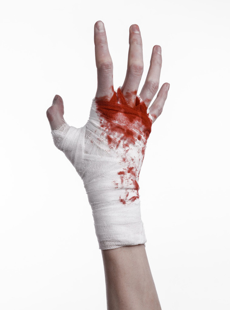 shook his bloody hand in a bandage, bloody bandage, fight club, street fight, violence, bloody theme, black background, isolated, bloody fists, boxer, tied his hands with a bandage, white background - Foto, Imagen