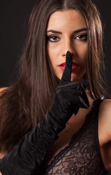 Sexy brunette woman with gloves saying shh - Фото, зображення