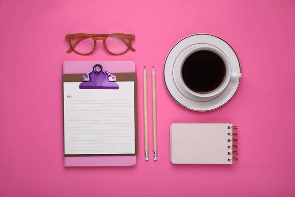 To do notes, stationery, planner and cup of coffee on pink background, flat lay. Space for text - Valokuva, kuva