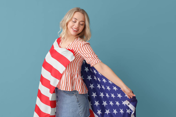 Young woman with USA flag on blue background - Photo, Image