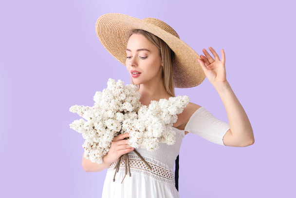 Young woman with lilac flowers on color background - Photo, Image
