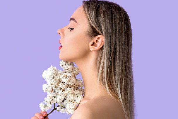 Młoda kobieta z liliowymi kwiatami na tle koloru, zbliżenie - Zdjęcie, obraz