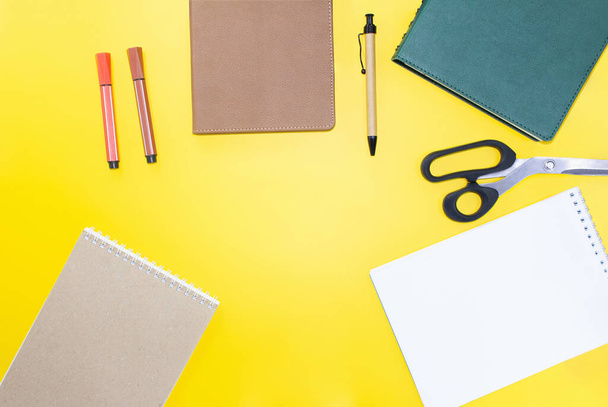 Back to school. Education flat lay. Business layout. Mock up, notepads, pen, marker, scissors on yellow background. Workplace. Copy space - Fotó, kép