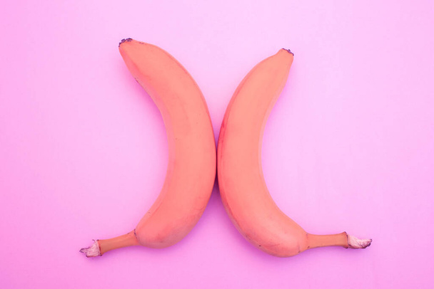 Banana in a pink shade on a pink background - Photo, Image