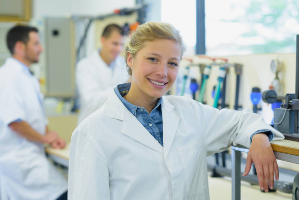 female worker in lab coats looking at camera - Фото, изображение