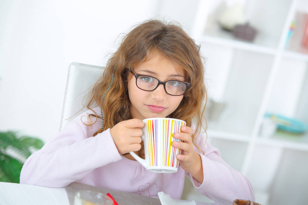 young girl drinking hot beverage - Fotó, kép