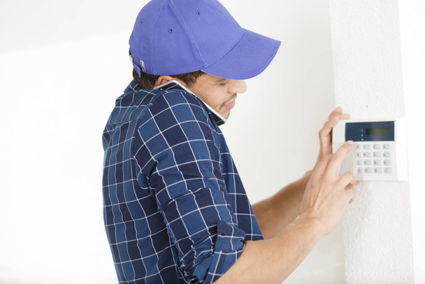 man on the phone works on temperature thermostat - Photo, Image