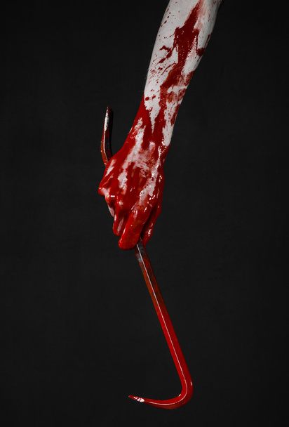 Bloody hands with a crowbar, hand hook, halloween theme, killer zombies, black background, isolated, bloody crowbar - Фото, изображение