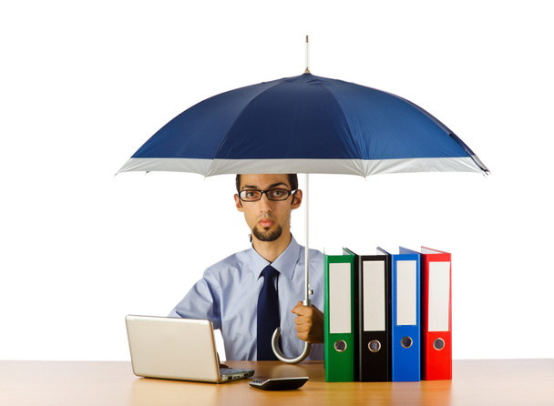 Businessman holding umbrella in the office - Photo, Image