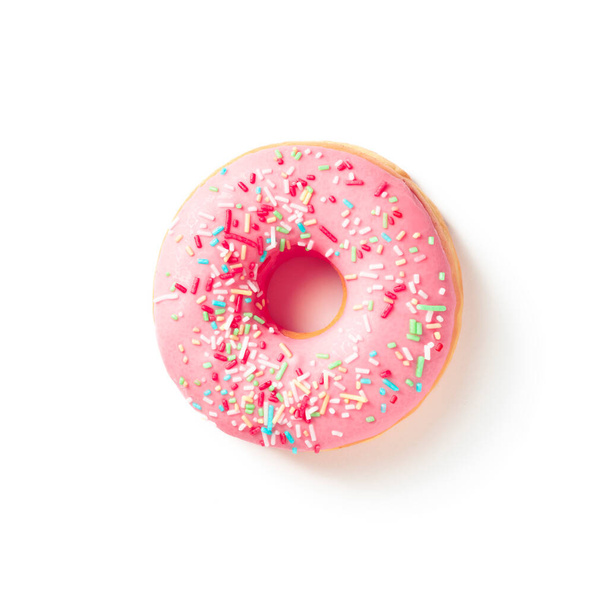 Sweet donut in colored pink glaze on a white background top view - Foto, immagini