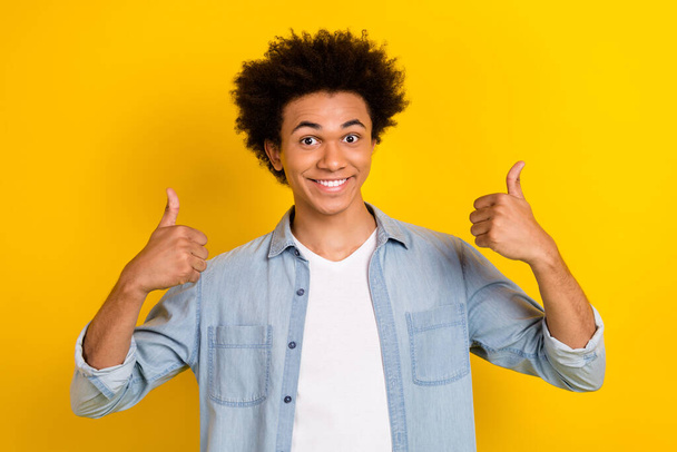 Photo of confident excited man wear jeans shirt showing two thumbs up isolated yellow color background. - Fotografie, Obrázek