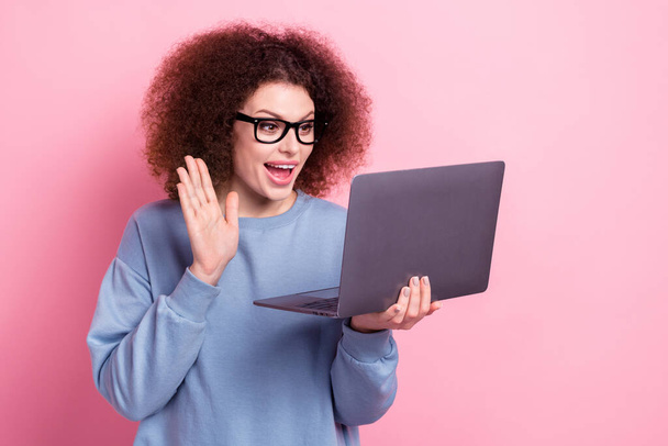 Photo of funky excited lady dressed blue pullover eyewear communicating modern device isolated pink color background. - 写真・画像