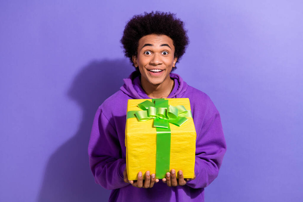 Photo of cheerful impressed person arms hold get desirable giftbox unbelievable reaction isolated on violet color background. - Foto, afbeelding