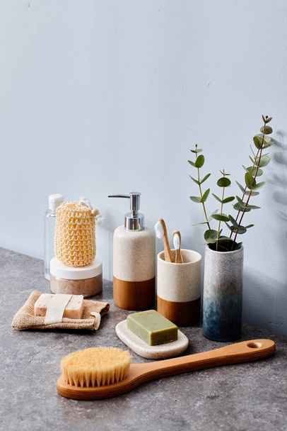 Cepillo para masaje corporal, paño y otros artículos de tocador en la mesa en el baño - Foto, Imagen