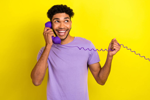 Photo of funky excited person have good mood speak communicate retro cable telephone isolated on yellow color background. - Фото, изображение