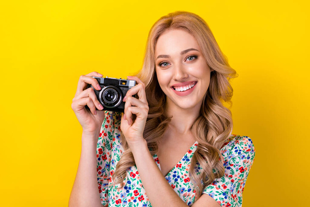 Photo of positive gorgeous cute lady wear trendy clothes buy new quality camera walk make picture isolated on yellow color background. - Fotoğraf, Görsel