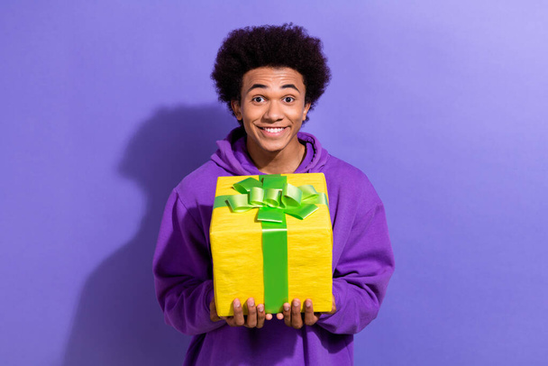 Photo of excited funky person beaming smile hands hold receive desirable giftbox isolated on violet color background. - Foto, imagen