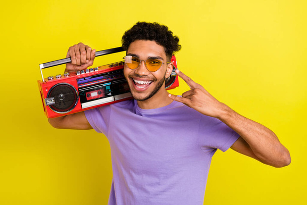 Photo of young guy have fun childish mood punk rock roll metal music crazy hipster listen boombox isolated on yellow color background. - Foto, Bild