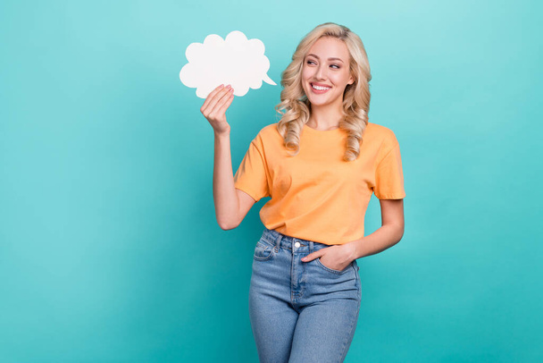 Photo of dreamy adorable lady dressed orange t-shirt looking holding speaking cloud empty space isolated teal color background. - Zdjęcie, obraz